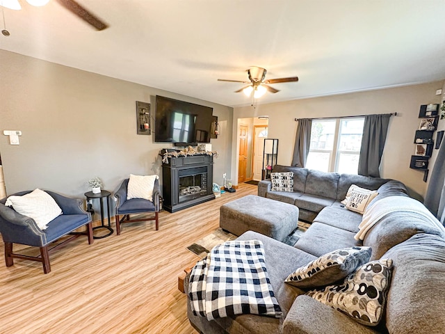 101 6th St, Minot, ND 58703 - living area with ceiling fan, light wood-style floors, and a fireplace