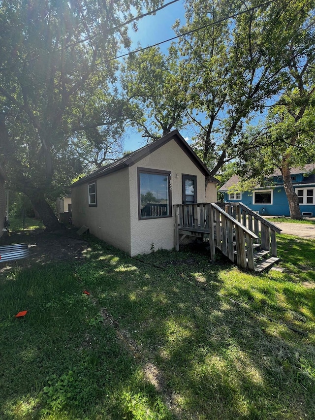 622 Central Ave, Minot, ND 58701 - view of home's exterior featuring stucco siding and a yard