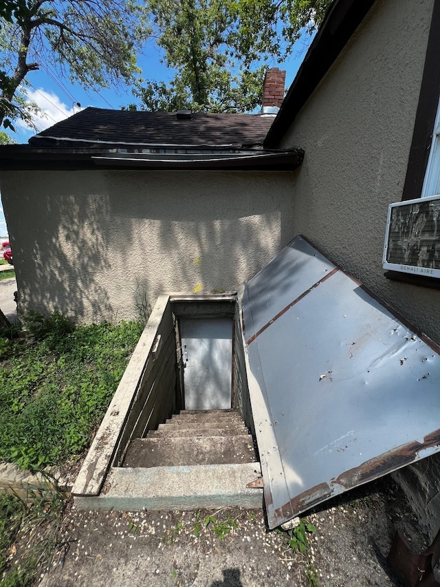 622 Central Ave, Minot, ND 58701 - exterior view of stucco siding, a bulkhead entry, and a chimney