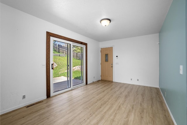 1127 8th St, Minot, ND 58703 - unfurnished room with light wood finished floors and baseboards