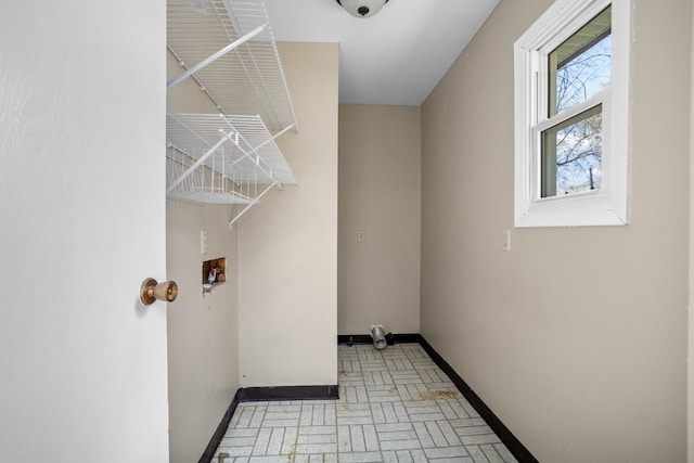 1127 8th St, Minot, ND 58703 - washroom with baseboards, washer hookup, and brick patterned flooring