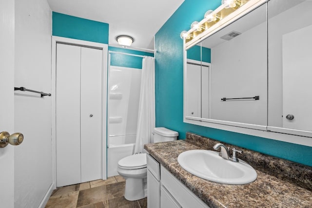 1127 8th St, Minot, ND 58703 - bathroom with vanity, toilet, shower / bath combination with curtain, and stone finish flooring