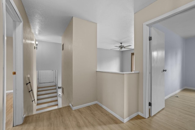 1127 8th St, Minot, ND 58703 - hall with wood finished floors, baseboards, and an upstairs landing
