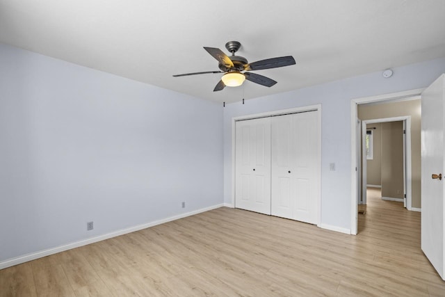 1127 8th St, Minot, ND 58703 - unfurnished bedroom with light wood-style flooring, baseboards, a closet, and ceiling fan