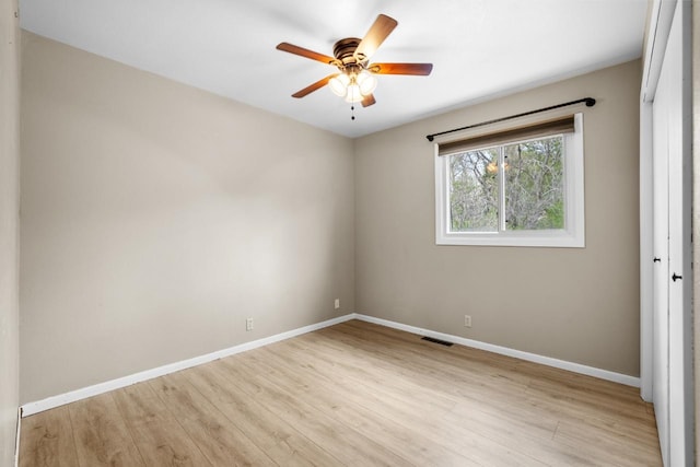 1127 8th St, Minot, ND 58703 - unfurnished room with baseboards, ceiling fan, and light wood finished floors