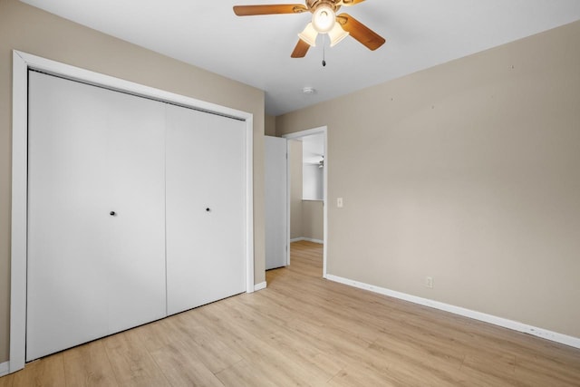 1127 8th St, Minot, ND 58703 - unfurnished bedroom with light wood finished floors, a closet, baseboards, and a ceiling fan
