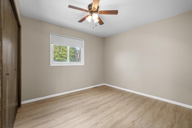 1127 8th St, Minot, ND 58703 - unfurnished bedroom with light wood-style flooring, baseboards, a closet, and ceiling fan