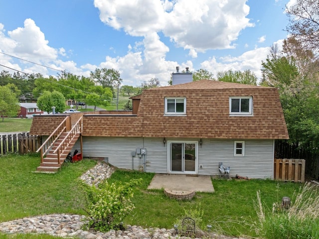 1127 8th St, Minot, ND 58703 - back of property featuring roof with shingles, a chimney, a patio, and mansard roof