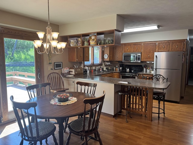 1130 8th St, Minot, ND 58703 - dining room with wood finished floors and a chandelier