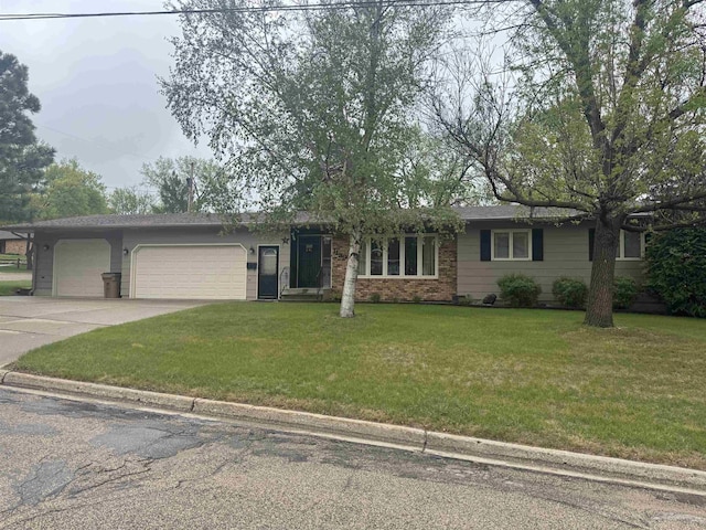 1130 8th St, Minot, ND 58703 - ranch-style home featuring an attached garage, concrete driveway, and a front yard
