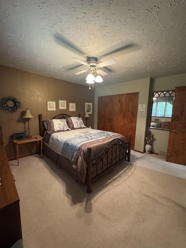 1130 8th St, Minot, ND 58703 - bedroom featuring light carpet, a textured ceiling, ceiling fan, and a closet