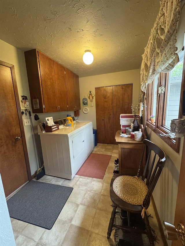 1130 8th St, Minot, ND 58703 - laundry area featuring cabinet space, separate washer and dryer, a textured ceiling, and light floors