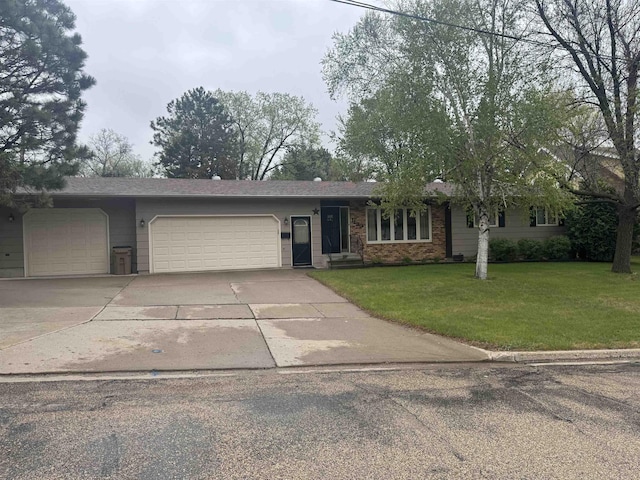 1130 8th St, Minot, ND 58703 - single story home featuring a garage, concrete driveway, and a front yard