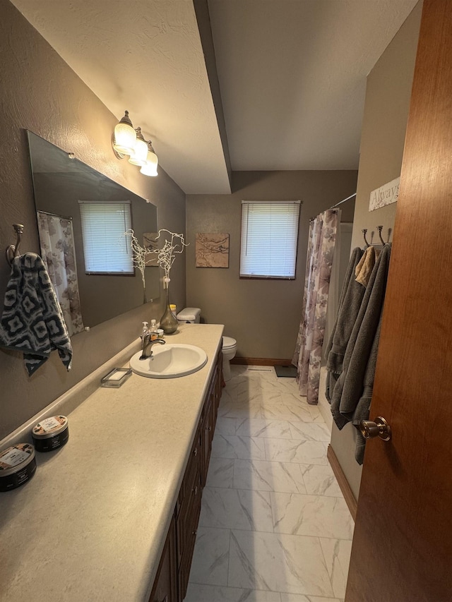 1130 8th St, Minot, ND 58703 - full bathroom with marble finish floors, toilet, vanity, and a shower with shower curtain