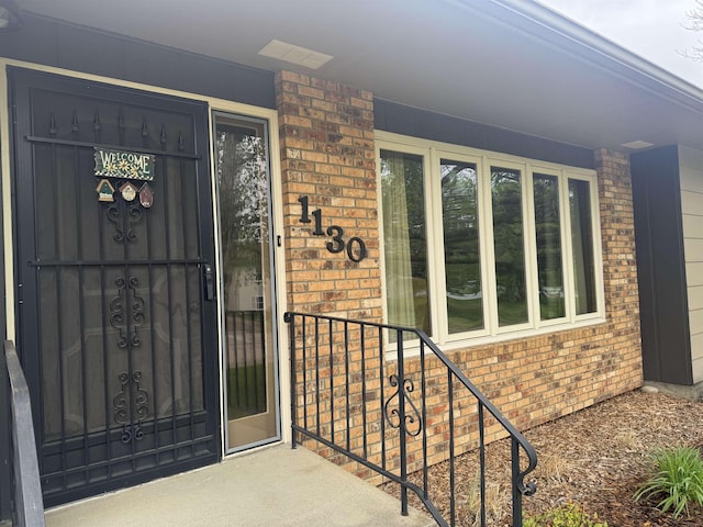 1130 8th St, Minot, ND 58703 - doorway to property with brick siding