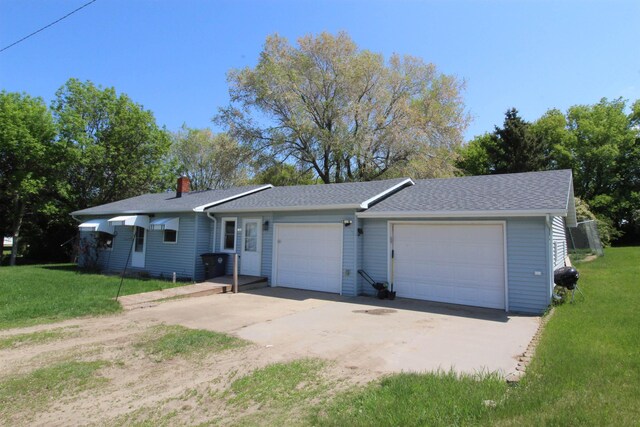 506 W Ave, Granville, ND 58741 - ranch-style home featuring a front lawn, an attached garage, a chimney, a shingled roof, and driveway