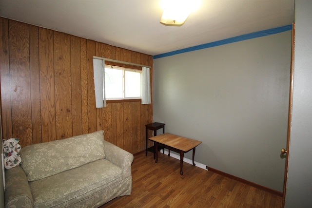 506 W Ave, Granville, ND 58741 - living area with wood finished floors, baseboards, and wood walls