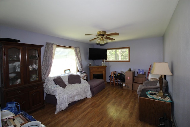 506 W Ave, Granville, ND 58741 - living room featuring wood finished floors, a ceiling fan, and a fireplace