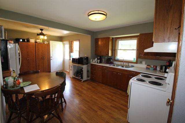 506 W Ave, Granville, ND 58741 - kitchen with under cabinet range hood, a sink, white appliances, dark wood finished floors, and light countertops
