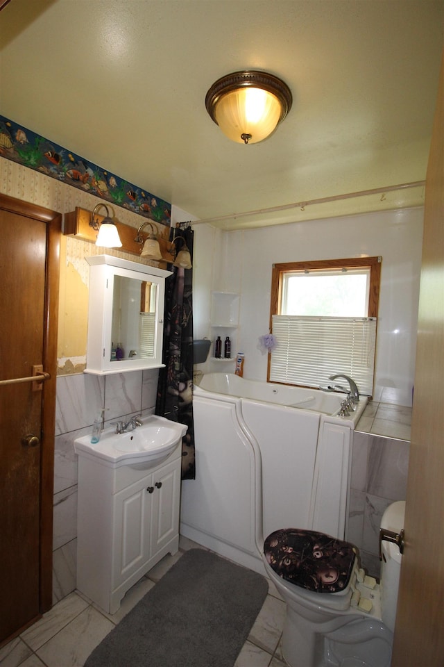 506 W Ave, Granville, ND 58741 - full bath featuring vanity, a garden tub, toilet, and marble finish flooring