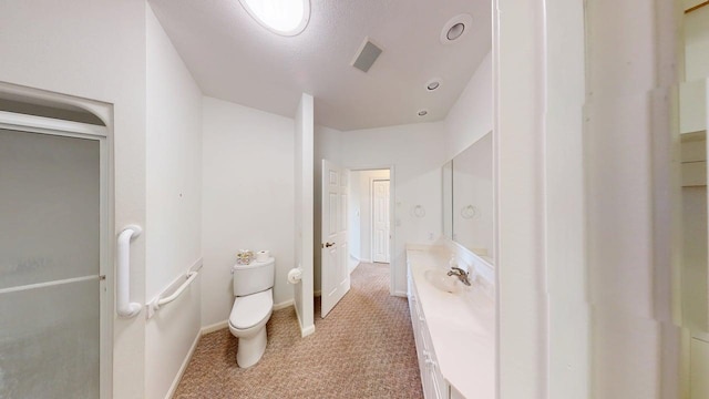 2700 18th Ave, Minot, ND 58701 - bathroom featuring vanity, toilet, and baseboards