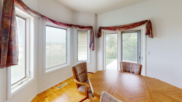 2700 18th Ave, Minot, ND 58701 - dining room featuring light wood-type flooring and baseboards