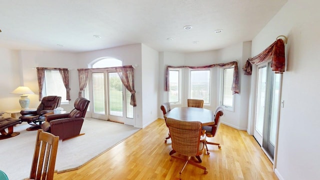 2700 18th Ave, Minot, ND 58701 - dining room featuring light wood-style flooring, healthy amount of natural light, and baseboards