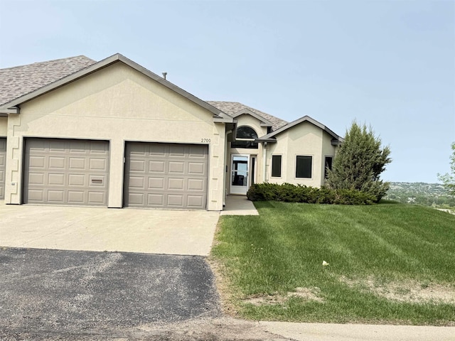2700 18th Ave, Minot, ND 58701 - single story home with a garage, concrete driveway, a front yard, stucco siding, and roof with shingles