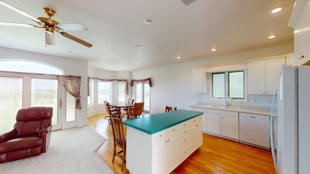 2700 18th Ave, Minot, ND 58701 - kitchen featuring white appliances, a sink, white cabinetry, a center island, and recessed lighting