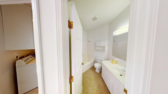 2700 18th Ave, Minot, ND 58701 - bathroom with washer / clothes dryer, vanity, and toilet