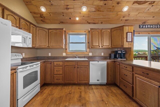 1164 100th St, Bottineau, ND 58318 - kitchen with white appliances, a sink, wooden ceiling, dark countertops, and light wood-style floors