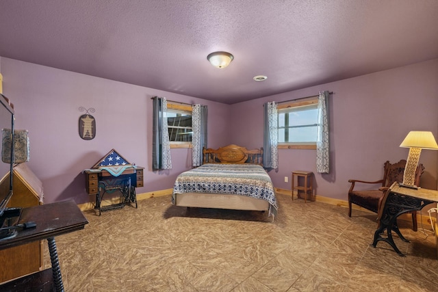 1164 100th St, Bottineau, ND 58318 - bedroom featuring baseboards and a textured ceiling