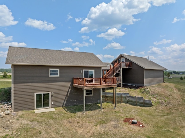 1164 100th St, Bottineau, ND 58318 - back of house with a deck, stairway, and a lawn