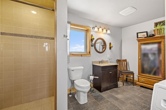 1164 100th St, Bottineau, ND 58318 - full bathroom with vanity, a tile shower, toilet, washer / dryer, and baseboards