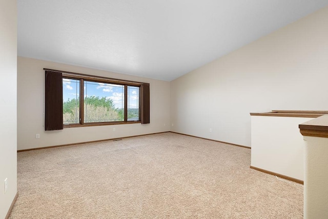 1600 16th St, Minot, ND 58701 - unfurnished room with light colored carpet, baseboards, and vaulted ceiling