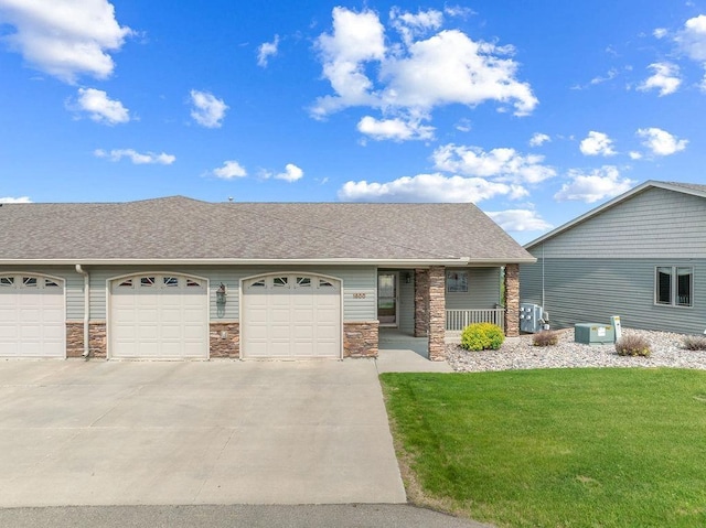 1600 16th St, Minot, ND 58701 - view of front of house with a porch, a front lawn, driveway, and roof with shingles