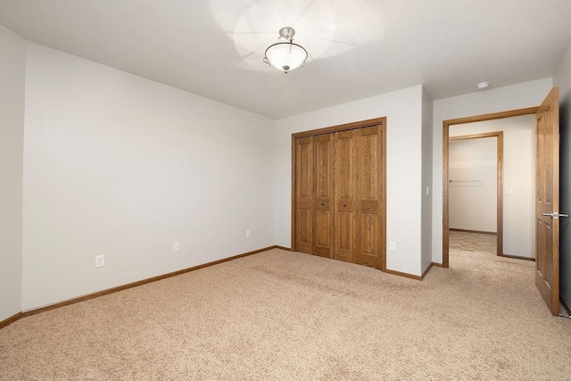 1600 16th St, Minot, ND 58701 - unfurnished bedroom with light carpet, a closet, and baseboards