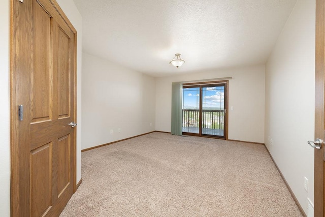 1600 16th St, Minot, ND 58701 - unfurnished room with light colored carpet, baseboards, and a textured ceiling
