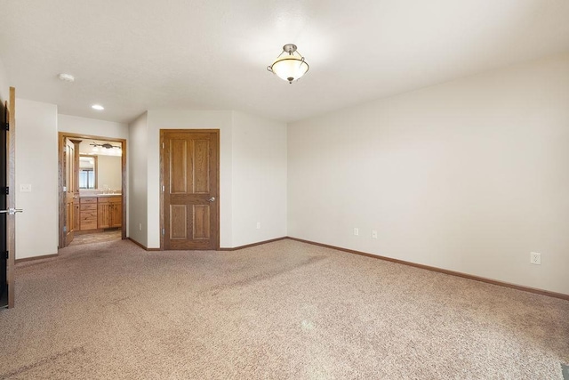 1600 16th St, Minot, ND 58701 - spare room with light carpet, baseboards, a smoke detector, and recessed lighting