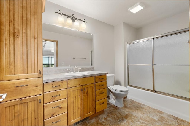 1600 16th St, Minot, ND 58701 - full bathroom with toilet, vanity, and enclosed tub / shower combo