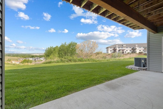 1600 16th St, Minot, ND 58701 - view of grassy yard featuring central air condition unit and a patio area