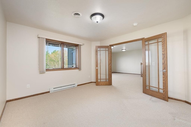 1600 16th St, Minot, ND 58701 - spare room featuring a baseboard heating unit, french doors, and light colored carpet