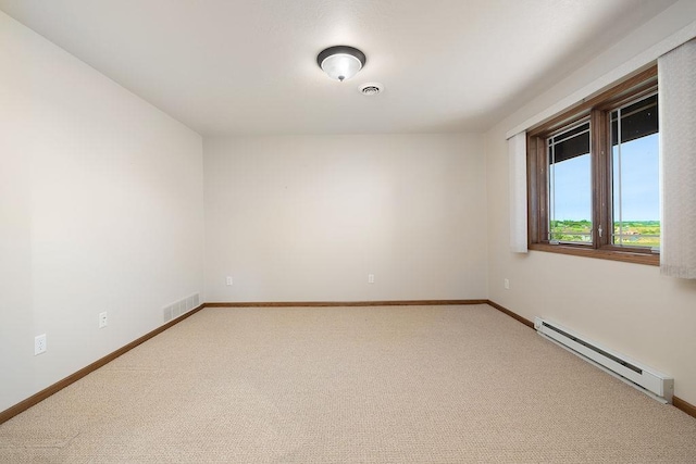 1600 16th St, Minot, ND 58701 - unfurnished room featuring a baseboard heating unit, light colored carpet, and baseboards
