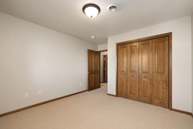 1600 16th St, Minot, ND 58701 - unfurnished bedroom with light carpet, baseboards, and a closet