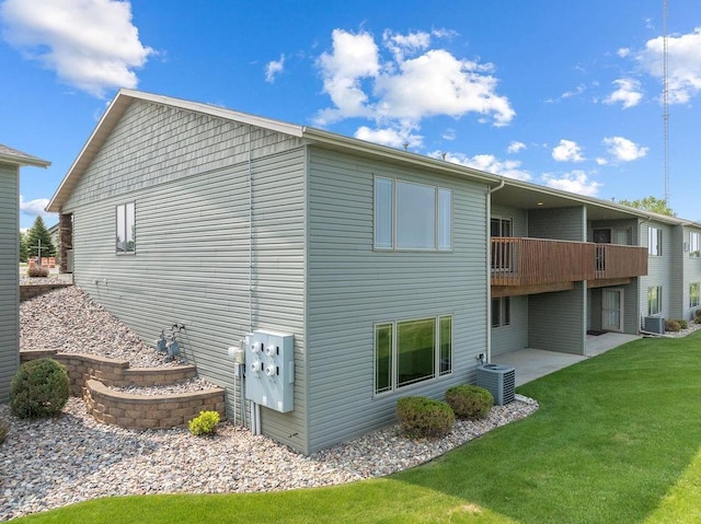 1600 16th St, Minot, ND 58701 - rear view of property featuring a yard, central AC unit, a balcony, and a patio