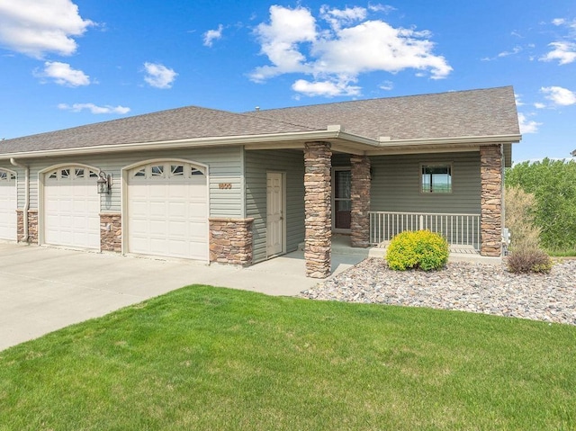 1600 16th St, Minot, ND 58701 - view of front of home featuring stone siding, an attached garage, driveway, a front lawn, and a porch