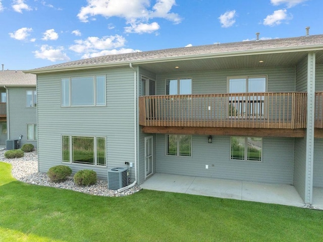 1600 16th St, Minot, ND 58701 - rear view of house with a balcony, cooling unit, and a lawn