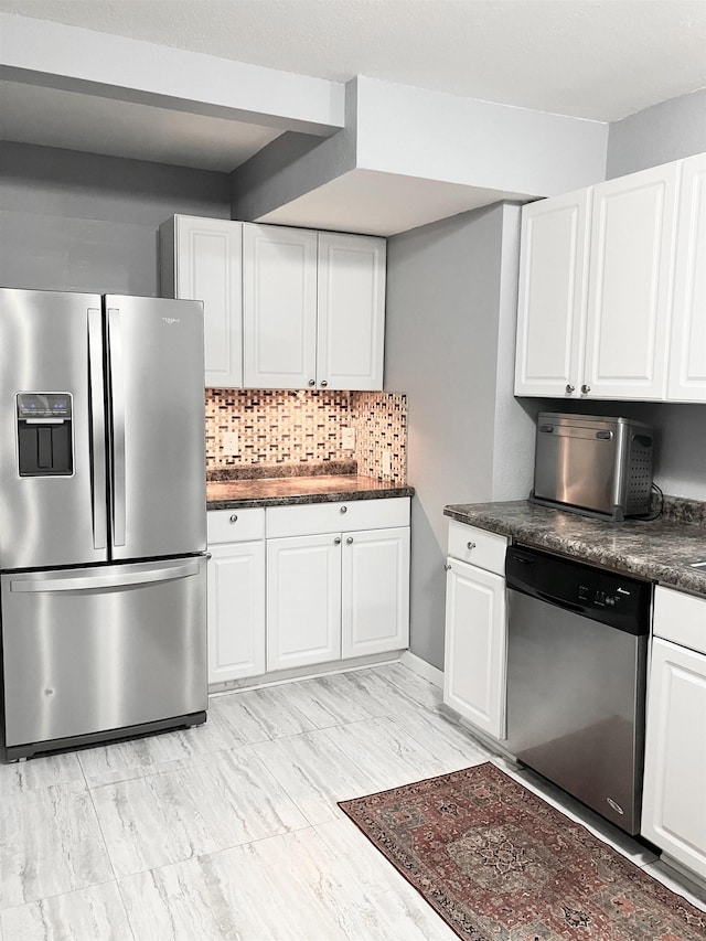 430 NW 2nd Ave, Minot, ND 58703 - kitchen featuring appliances with stainless steel finishes, dark countertops, white cabinets, and backsplash