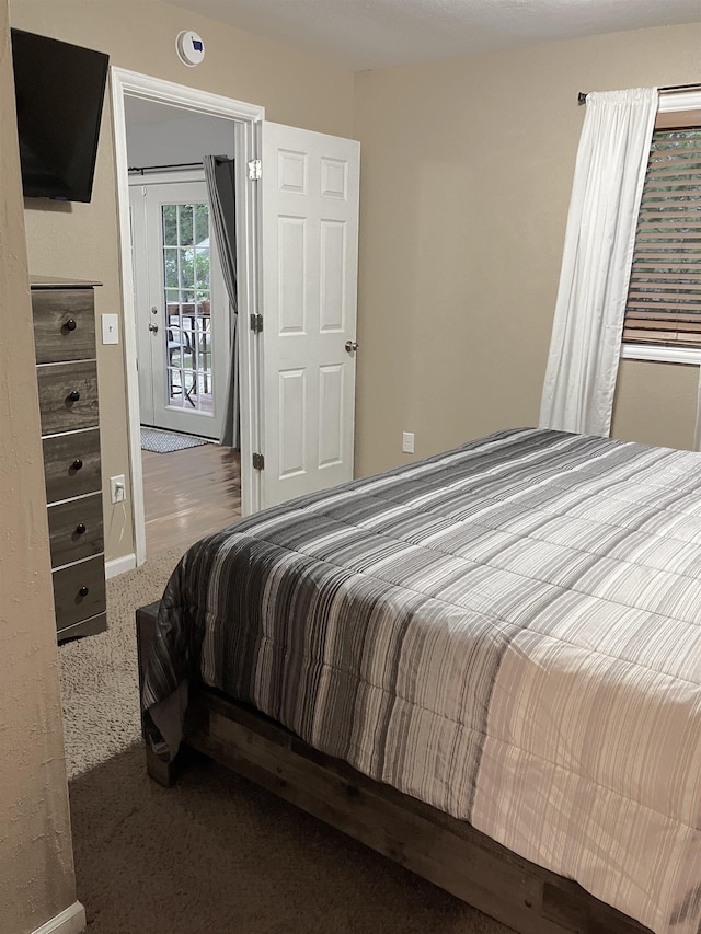 430 NW 2nd Ave, Minot, ND 58703 - carpeted bedroom featuring baseboards and access to outside