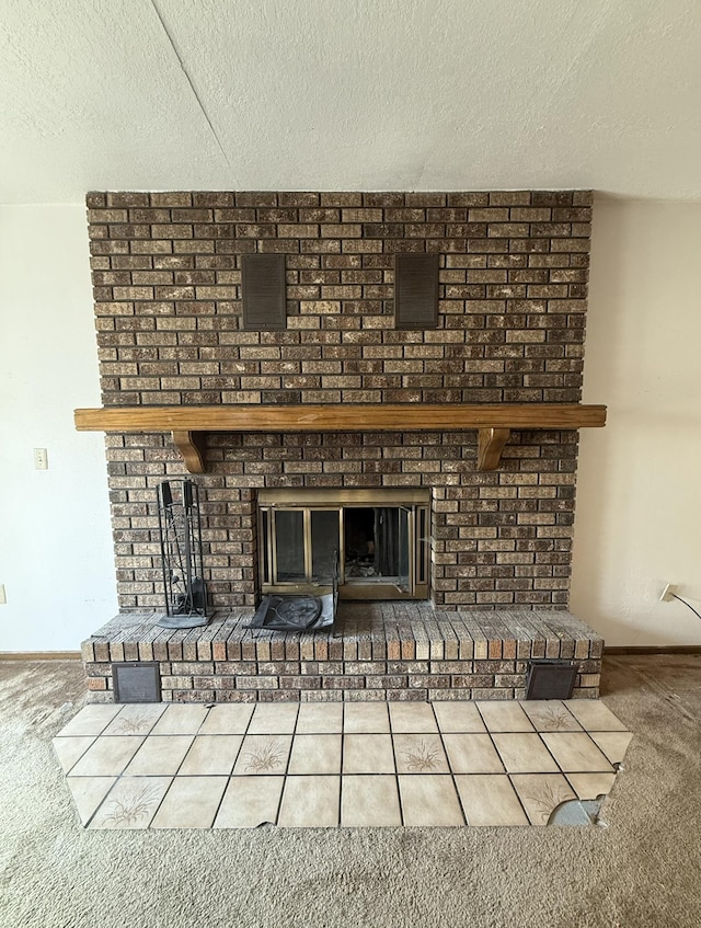 619 25th Ave, Minot, ND 58703 - detailed view of a fireplace, carpet flooring, a textured ceiling, and baseboards
